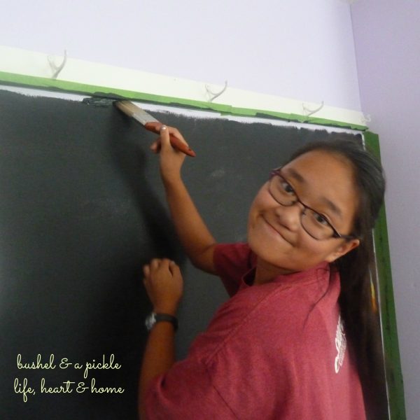 Meg painting black board