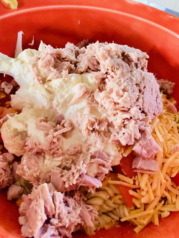 stir in pasta, cheese, sweet peppers, tuna and mayo in large orange bowl