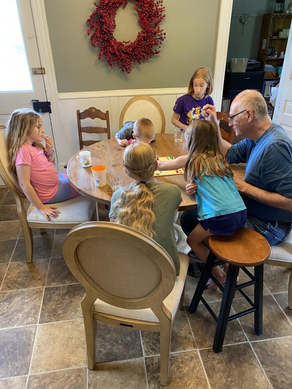 More games with Grandpa and grandkids at kitchen table