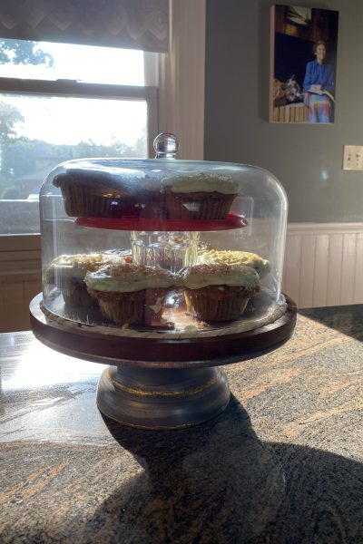 carrot cupcake in cake stand with glass cover