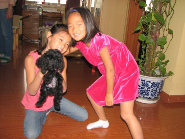 Amy and Meg holding baby Shadow, the 'black' dog