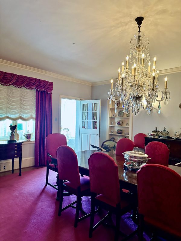 Classic Red Dining Room with Crystal Chandelier and Silver