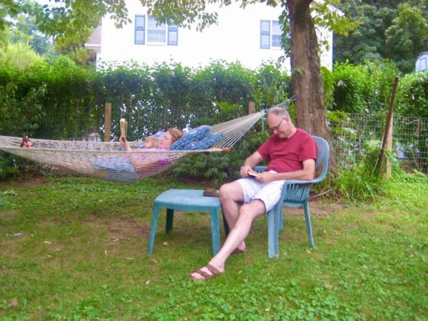 Backyard hammock and chair with resting people