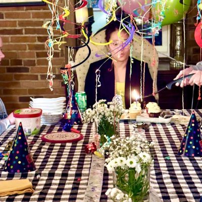 Tablescape with Meg blowing out candle