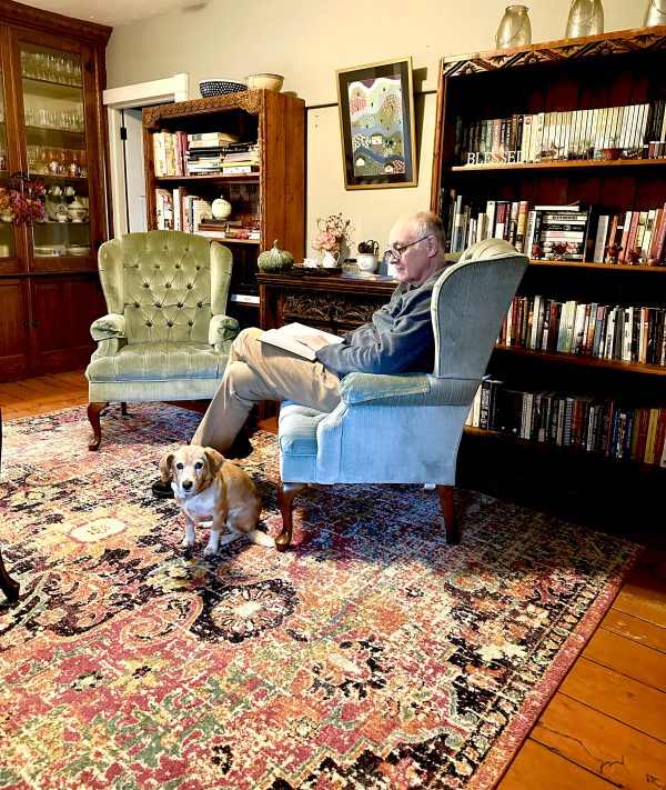 JIm sitting and reading in blue chair