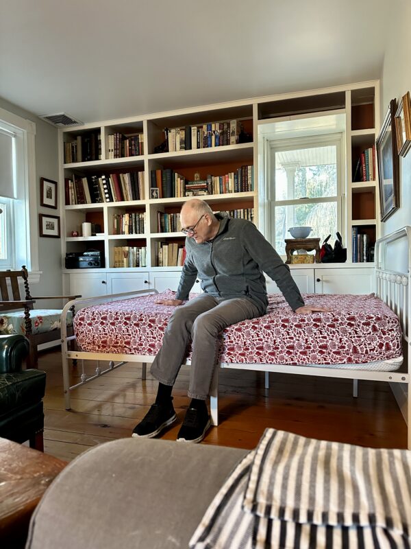Jim on bed set up in living room