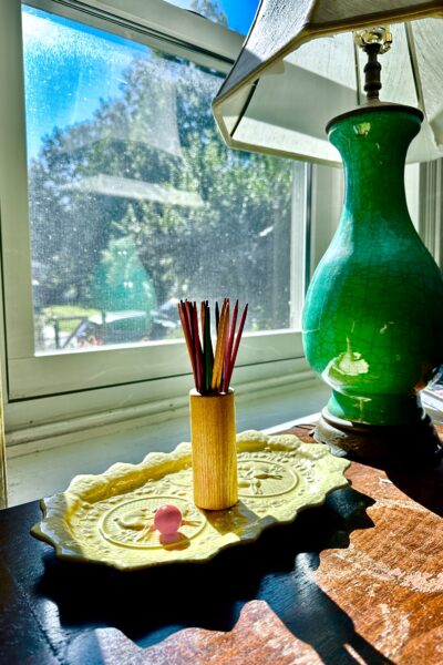 Pick up sticks on yellow platter with dark jade green on top of small buffet