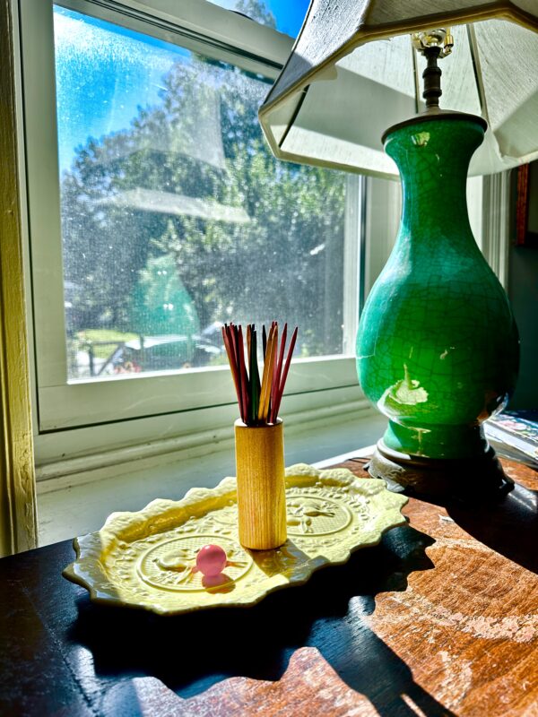 Pick up sticks on yellow platter with dark jade green on top of small buffet
