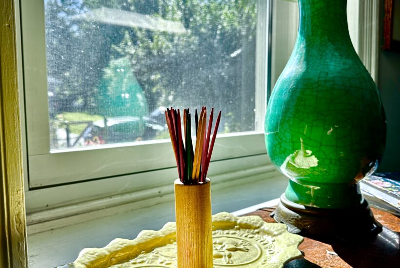 Pick up sticks on yellow platter with dark jade green on top of small buffet